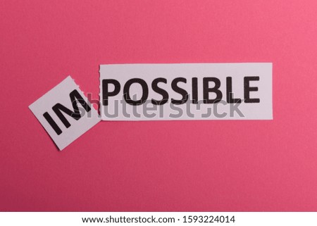 Impossible text cut out. Possible concept. Success. Pink background. Copy space. Vertical orientation. View from above. Minimal simple style