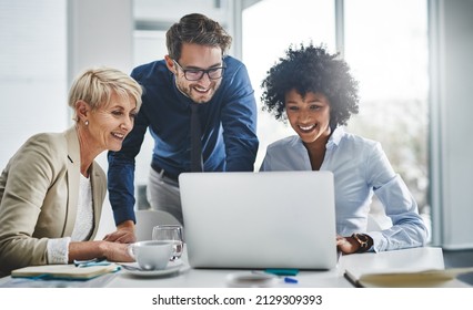 Its impossible until we show you that its possible. Shot of a group of businesspeople working together on a laptop. - Shutterstock ID 2129309393