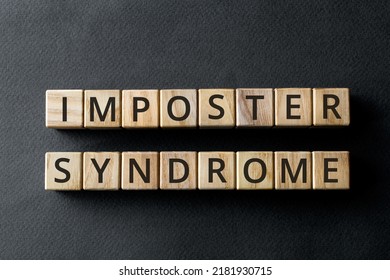 Impostor syndrome - phrase from wooden blocks with letters, psychological pattern inadequate incompetent Impostor syndrome concept, gray background