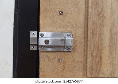 Imprecise installation of sliding bolt lock on wooden door