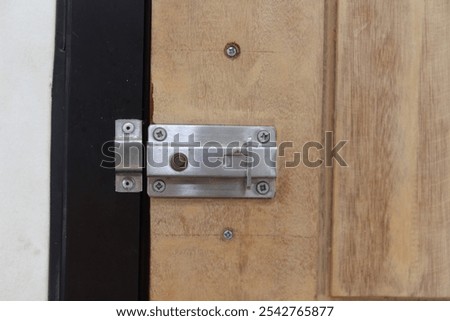 Imprecise installation of sliding bolt lock on wooden door