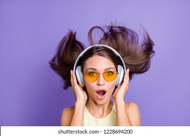 Impressed attractive beautiful good-looking adorable lady with her style spectacles she look at camera open mouth isolated on bright shine violet purple wall listen best beat track sound