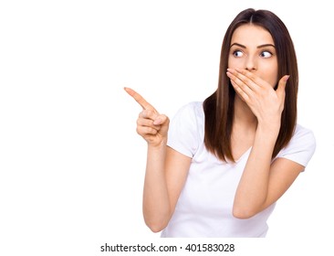 I'm Impressed! Studio Shot Of Surprised Attractive Woman Pointing Away Over White Background