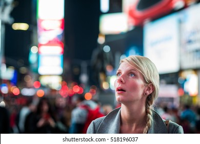 Impressed Woman In The Middle Of Times Square At Night,