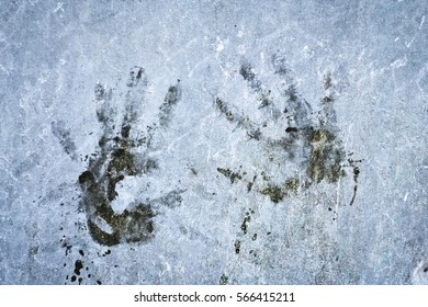 impression of human hands on the rough wall