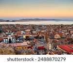 Impressive aerial view of lake Titicaca at sunset from Huajsapata Hill viewpoint, Puno, Peru