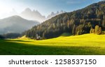 Impressive Athmospheric landcape. Breathtaking view of St Johann Church of Santa Maddalena, with the majestic Dolomites mountains in the background 