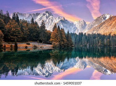 Impressive Autumn landscape during sunset.  The Fusine Lake in front of the Mongart under sunlight. Amazing sunny day on the mountain lake. concept of an ideal resting place. Creative image. - Shutterstock ID 1459051037