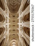The impressive Gothic vaulted ceiling and intricate ribbing of Saint Pierre Cathedral in Nantes, France, showcase architectural grandeur.
