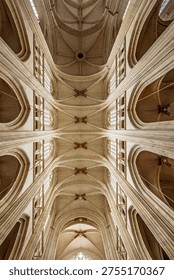 The impressive Gothic vaulted ceiling and intricate ribbing of Saint Pierre Cathedral in Nantes, France, showcase architectural grandeur.