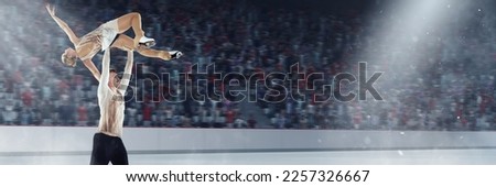 Impressive, graceful show. Young man and woman in beautiful stage costumes, professional figure skaters dancing on ice rink. 3D arena. Concept of sport, achievements, championship, talent. 3D arena