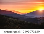 Impressive layers of mountain ranges and silhouettes ridgelines going into the distance in the sunlight. Location place Carpathian mountains, Ukraine, Europe. Photo wallpaper. Beauty of earth.