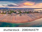 Impressive summer view from flying drone of Libera Rimini public beach. Wonderful summer scene of Italy, Europe. Superb evening view of Adriatic coast. Traveling concept background.