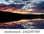 impressive sunset at lake laberge in Yukon Territory, Canada, reflection of epic colourful clouds