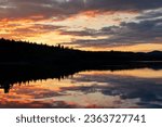 impressive sunset at lake laberge in Yukon Territory, Canada, reflection of epic colourful clouds