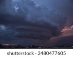 An impressive supercell thunderstorm with a powerful dramatic structure and high lightning intensity 
moves across the night sky over the eastern German city of Chemnitz in summer.