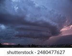 An impressive supercell thunderstorm with a powerful dramatic structure and high lightning intensity 
moves across the night sky over the eastern German city of Chemnitz in summer.