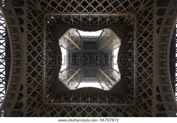 Impressive and unusual\
perspective of the Eiffel Tower (Paris, France), seen from directly\
below. Useful file for your brochure or flyer about France culture\
and toursim.