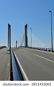 Impressive vertical view of an empty roadway and towering pylons on a modern cable stayed bridge under a clear sky, Fukushima Japan.
