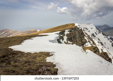 Impressive view from a Midzor summit, the highest peak of Old mountain, during transition period between winter and spring with some remaining snow and sunlit highlands