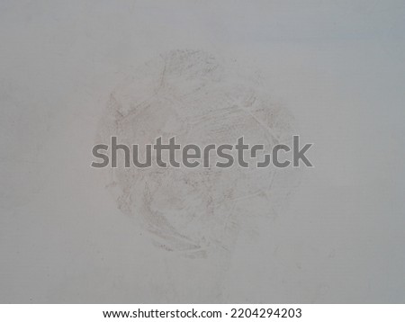 The imprint of a dirty soccer ball on the wall. Design element.