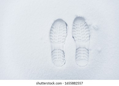 Imprint of shoes in the snow. Single clearly defined footprint of a shoes in snow.