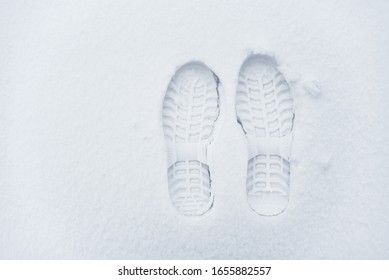 Imprint of shoes in the snow. Single clearly defined footprint of a shoes in snow. - Powered by Shutterstock