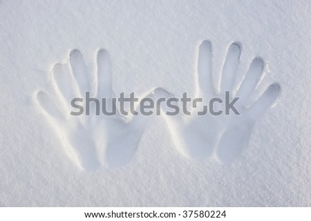 Imprint of two hands on the white sand