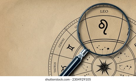 The imprint of the zodiac sign Leo on old paper is enlarged with a lens - Powered by Shutterstock