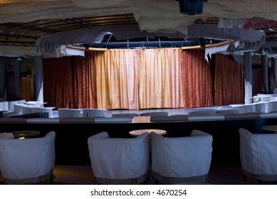 Improv Comedy Performing Stage Curtain With Chairs In Forground