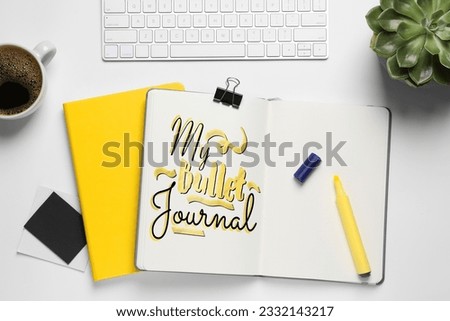 Improve your productivity. Notebook with words My bullet journal, keyboard, plant and cup of coffee on white table, flat lay
