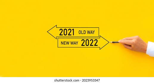 Improvement and change management. Businessman draw arrow panel with Old Way 2021 and New way of the  year 2022.