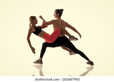 Improving flexibility through pilates training. Couple of athletes training together isolated on white. Athletic training. Physical training activity and sport. Fitness. - Shutterstock ID 1653697903