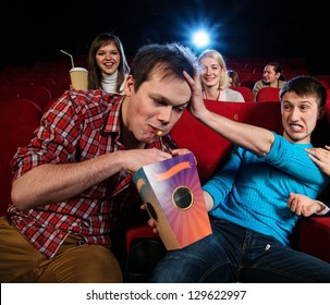 Impudent Young Man Steal Popcorn In Cinema While People Watching Movie