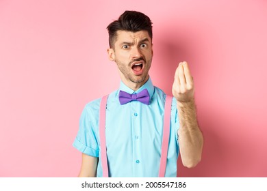 Impulsive Young Man Having An Arument, Prove Someone Wrong, Showing Italian Gesture And Complaining, Standing Over Pink Background