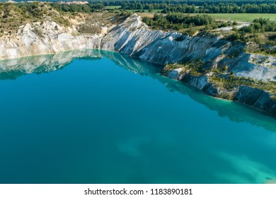 Inactive Gypsum Quarry. In The Quarry Is A Lake With Blue Water.