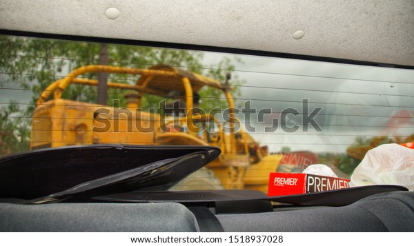 Inanam, Malaysia, Aug 31, 2019:\
Hitachi excavator. Image taken from inside a car. Image contain\
certain grain or noise and soft focus when view at full resolution.\

