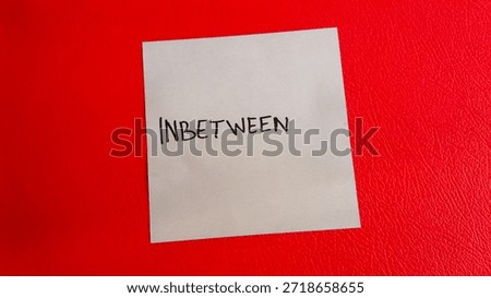 Inbetween writing on a red background
