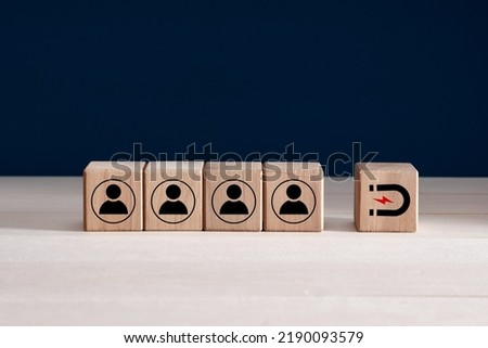 Inbound marketing strategy, customer retention, digital marketing and attracting potential customers in business concept. Wooden cubes with magnet icon attracts the customer icons.