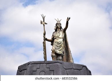 Incan statue standing high at a square in Cusco Peru.