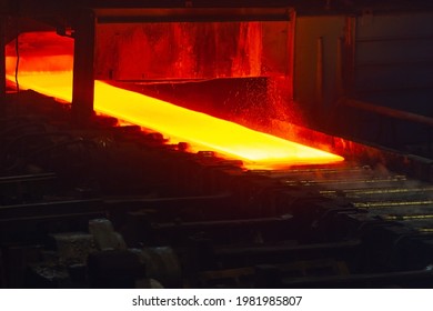 Incandescent hot rolled steel sheet in soft focus on a conveyor belt. Metallurgical production, hot rolling mill shop.  - Powered by Shutterstock