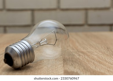 An incandescent lamp consumes much more electricity