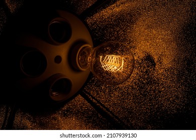 An incandescent lamp glows in the dark. Incandescent filament in a light bulb, creative.