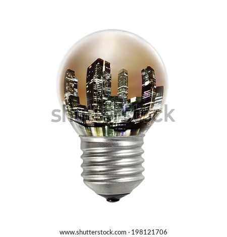 An incandescent light bulb with the night lights of London Canary Wharf city skyline for the concept of urban electrification.