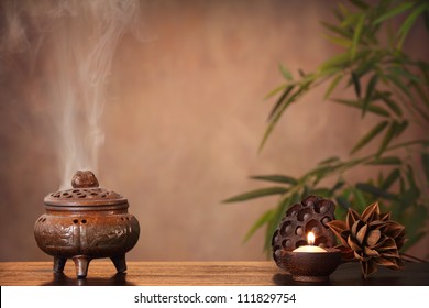 Incense burner and aromatic candle on table, Zen concept. - Powered by Shutterstock