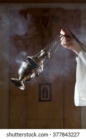 Incense burner held by a catholic priest. 