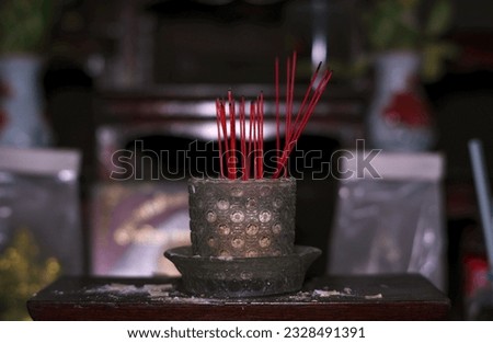 Incense burner set on a table In front of the altar of Buddha statues used to place incense sticks to pay homage to Saksit every day