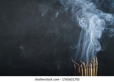 Incense burning incense, white smoke, black background, used as background image Paying homage to the sacred objects of the people of Buddhism according to their beliefs and beliefs. - Shutterstock ID 1765631705
