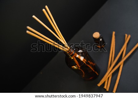 Incense diffuser with bamboo sticks for home freshness and aroma. Home-made aromatic substances.
