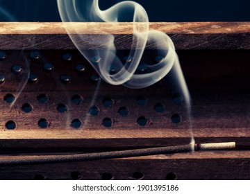 incense stick aroma with smoke  in a wooden handmade holder  isolated on background - Powered by Shutterstock